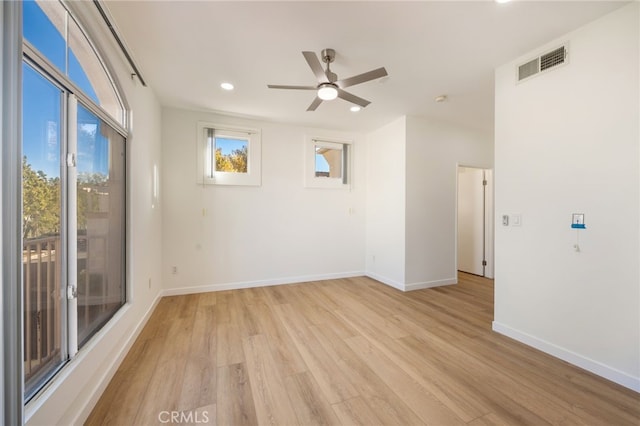 unfurnished room with a ceiling fan, baseboards, visible vents, recessed lighting, and light wood-type flooring