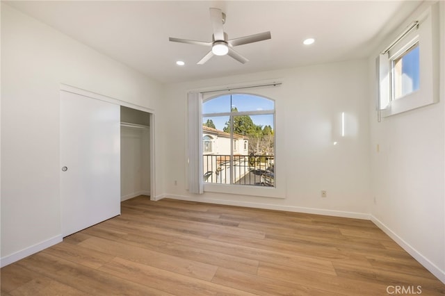 unfurnished bedroom with a closet, recessed lighting, baseboards, and light wood finished floors