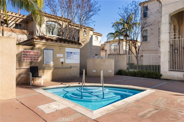 view of pool featuring fence