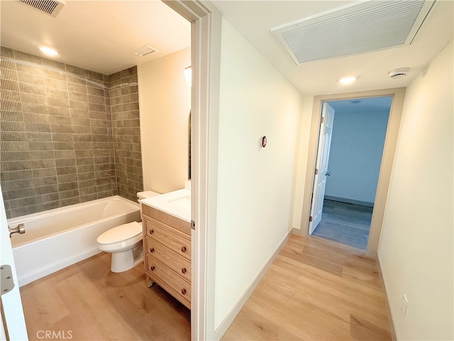 full bath with toilet, visible vents, wood finished floors, and shower / bath combination