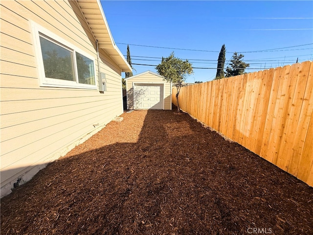 view of yard featuring an outbuilding and fence