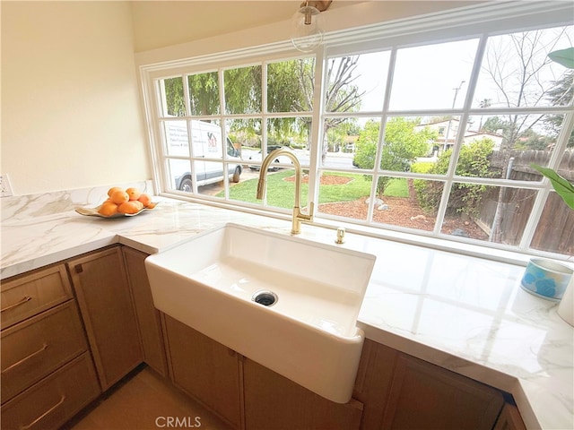 bathroom featuring a sink and a healthy amount of sunlight