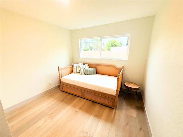 bedroom featuring baseboards and light wood-style floors