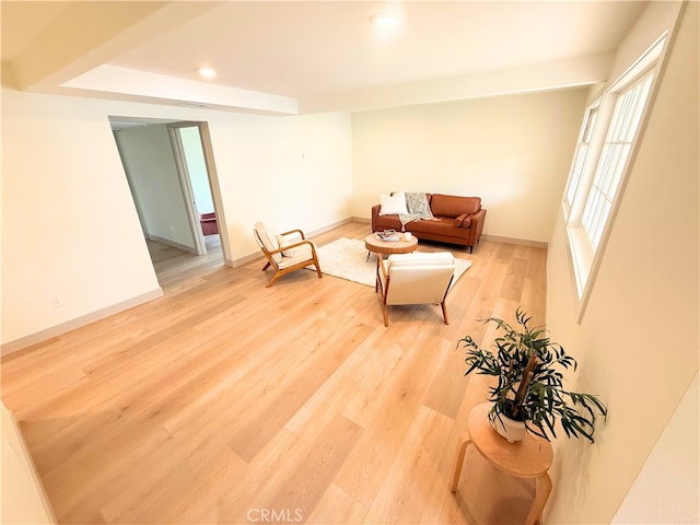 living area featuring recessed lighting, baseboards, and light wood finished floors