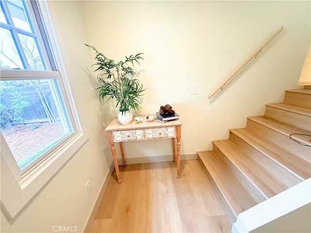 stairway featuring baseboards and wood finished floors