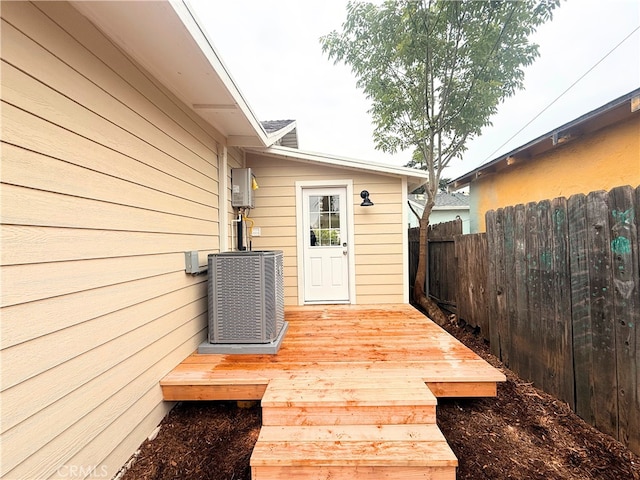 deck featuring cooling unit and fence