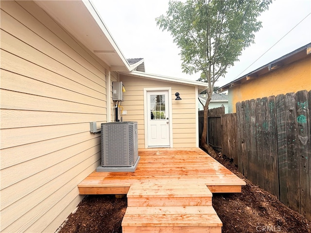 wooden deck with central air condition unit and fence