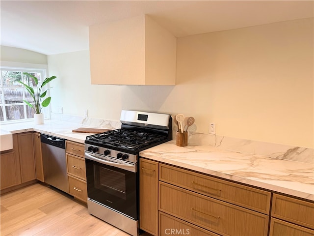 kitchen with light wood-style floors and appliances with stainless steel finishes