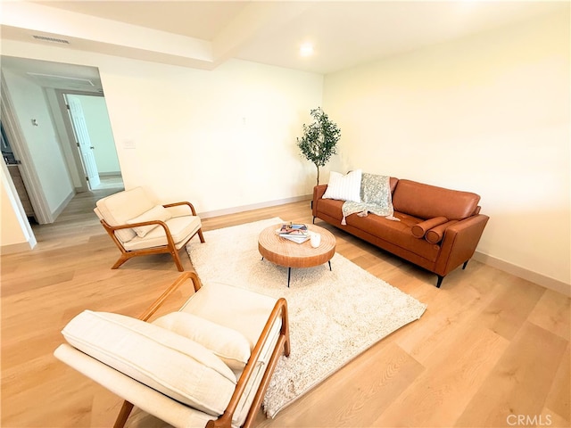 living room with light wood-style flooring, baseboards, visible vents, and recessed lighting