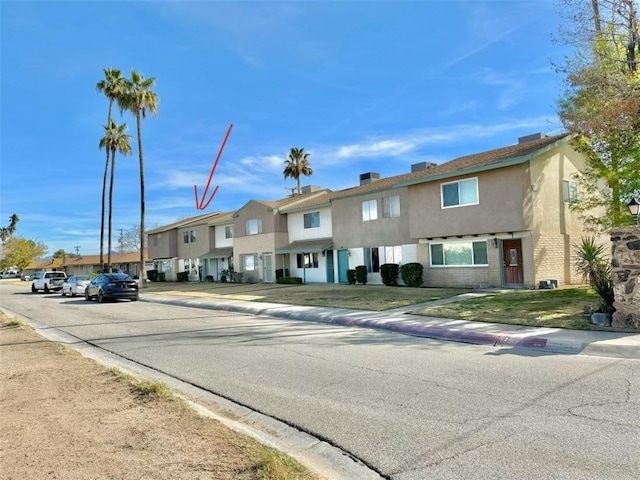 exterior space featuring a residential view, curbs, and sidewalks