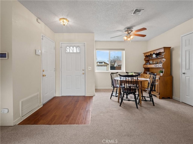 dining room with baseboards, carpet, visible vents, and ceiling fan