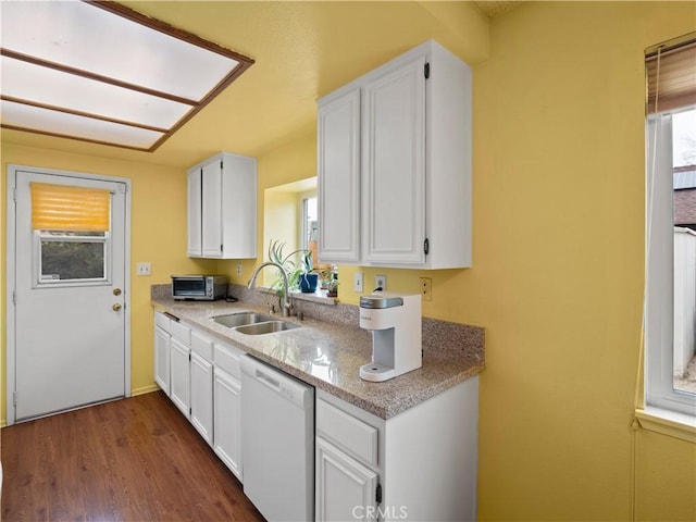 kitchen with a sink, white cabinets, and white dishwasher