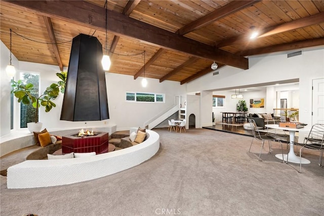 carpeted living area featuring lofted ceiling with beams, wood ceiling, and visible vents