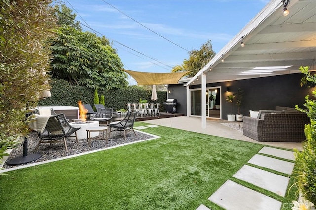 view of yard featuring an outdoor living space with a fire pit and a patio