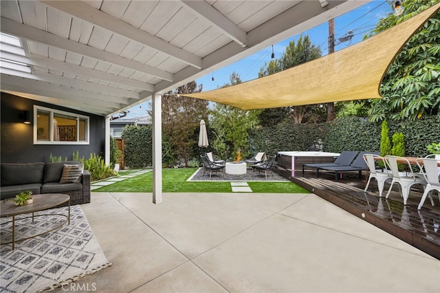 view of patio / terrace with an outdoor living space with a fire pit, a jacuzzi, and fence