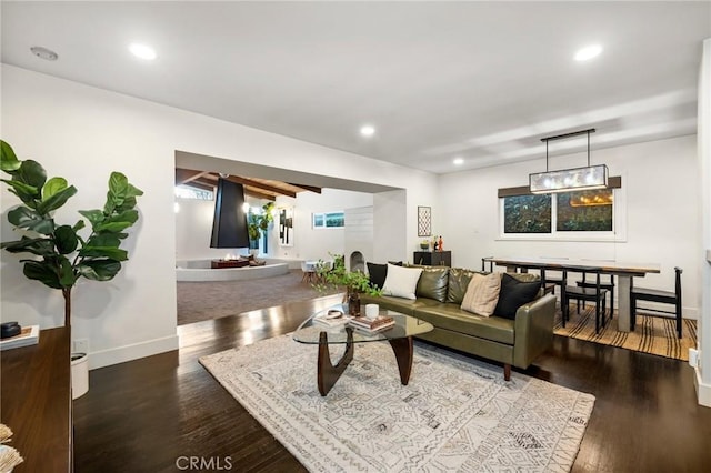 living area featuring recessed lighting, baseboards, and wood finished floors