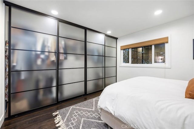 bedroom featuring recessed lighting and wood finished floors