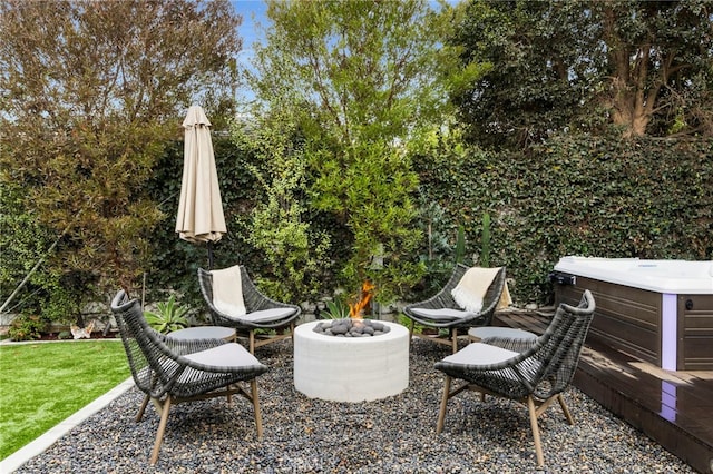 view of patio featuring a fire pit and a hot tub