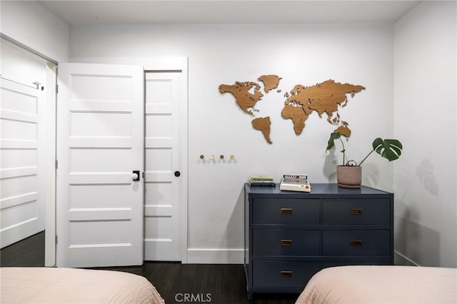 bedroom featuring dark wood-type flooring and baseboards