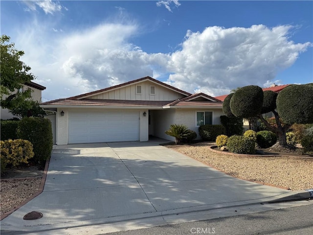 ranch-style house with board and batten siding, concrete driveway, and a garage