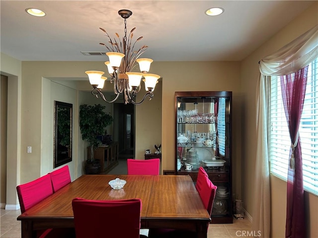 dining area featuring light tile patterned floors, visible vents, a wealth of natural light, and a chandelier