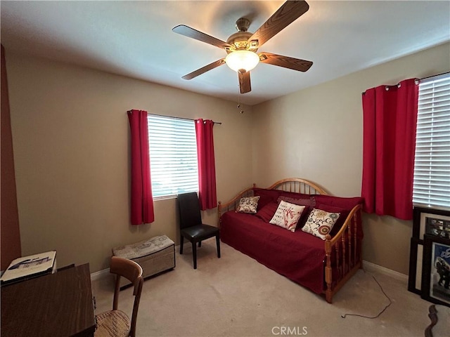 bedroom featuring ceiling fan, baseboards, and carpet