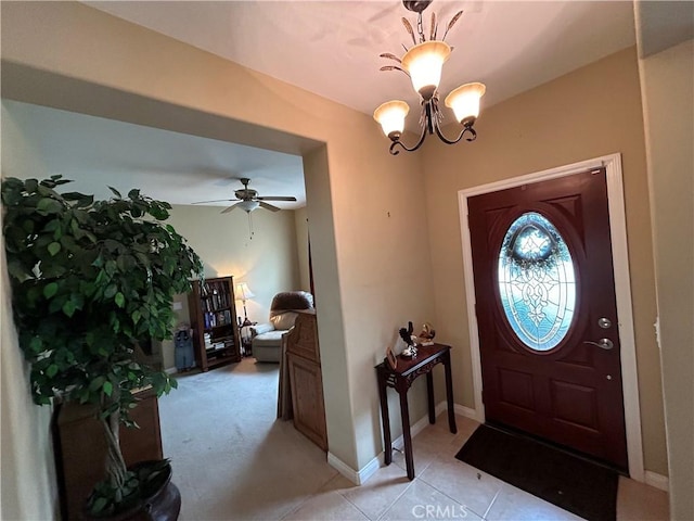 foyer entrance with an inviting chandelier, light tile patterned floors, and baseboards