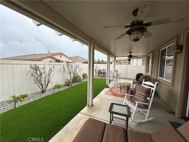 view of patio featuring a fenced backyard and ceiling fan