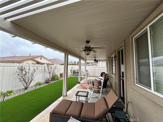 view of patio / terrace with a fenced backyard, outdoor lounge area, and a ceiling fan