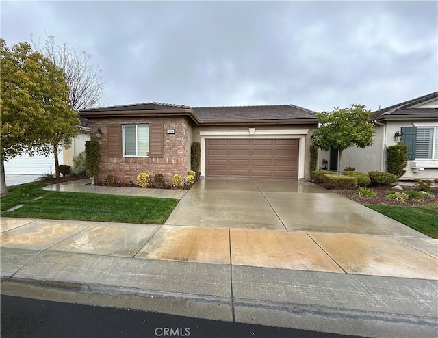 view of front of house featuring brick siding, a tile roof, concrete driveway, and a garage