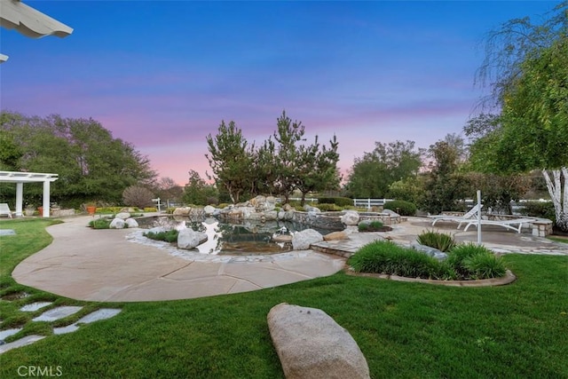 yard at dusk with a pergola and a patio