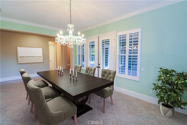 tiled dining area with a chandelier, baseboards, ornamental molding, and french doors