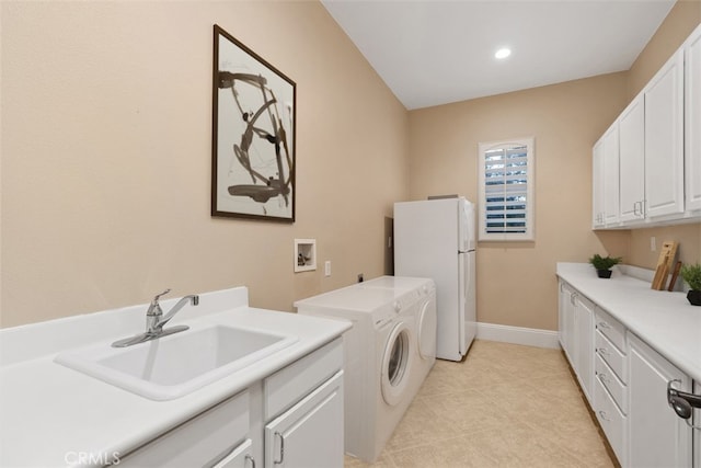 laundry area with hookup for a washing machine, baseboards, light tile patterned flooring, cabinet space, and a sink