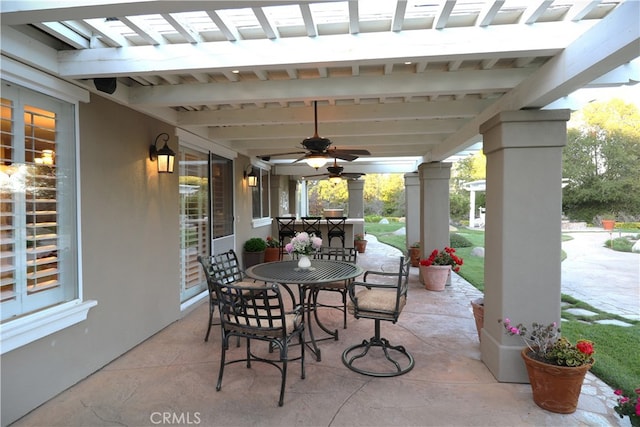 view of patio with outdoor dining area and ceiling fan