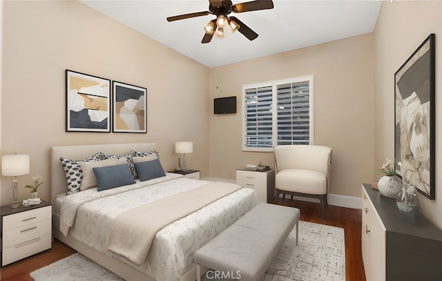 bedroom with a ceiling fan, baseboards, and wood finished floors