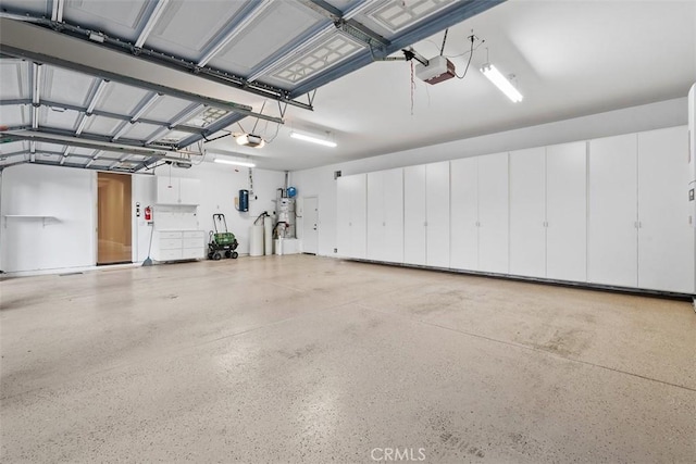 garage featuring a garage door opener and water heater