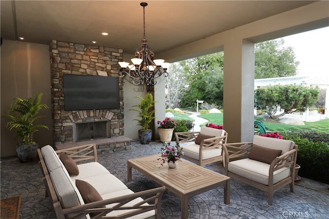 view of patio with an outdoor living space with a fireplace