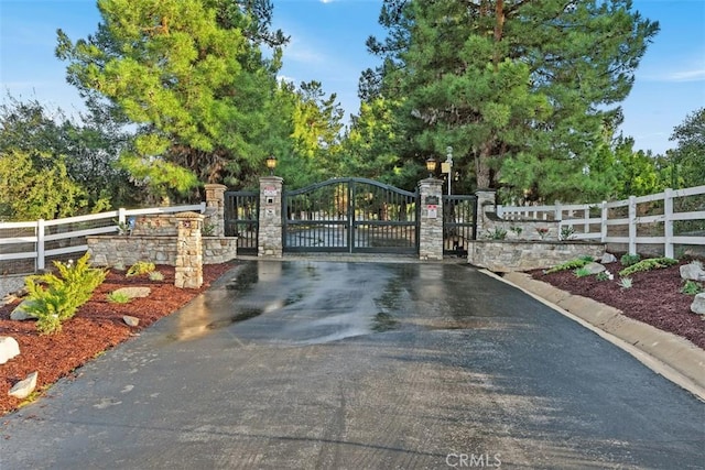 view of gate with fence