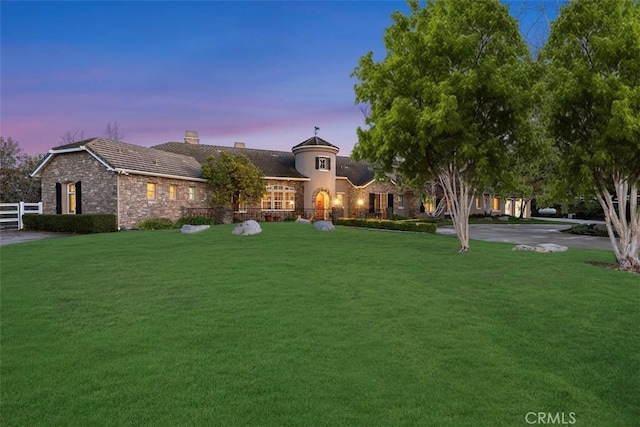 view of front of property featuring a chimney, a front yard, and fence