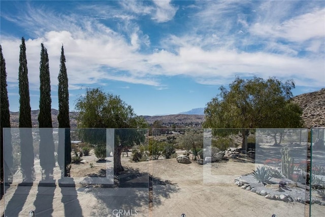 view of yard with a mountain view and fence