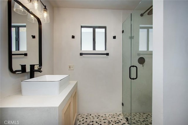 bathroom featuring a shower stall and vanity