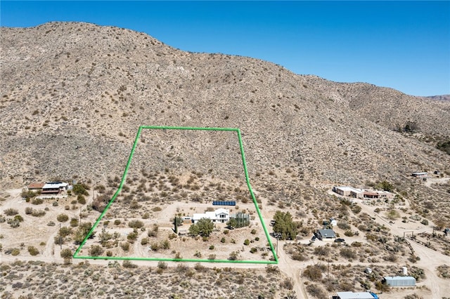 birds eye view of property featuring view of desert and a mountain view