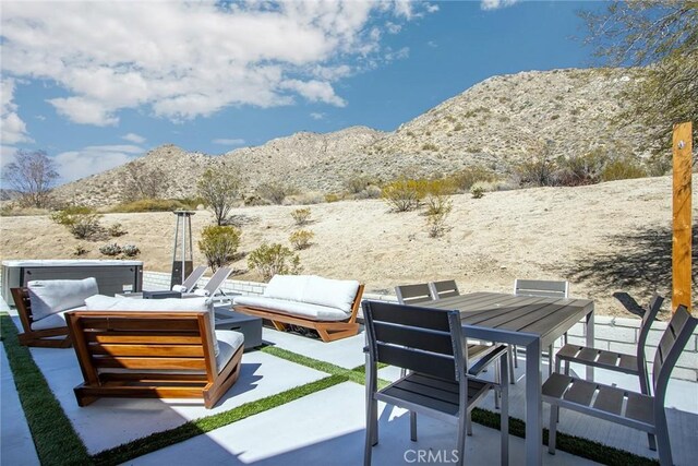 view of patio / terrace featuring outdoor lounge area, outdoor dining space, and a mountain view