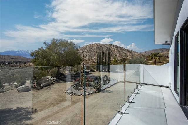 view of patio / terrace featuring a mountain view and fence