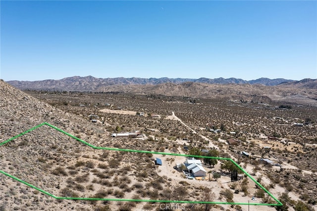 birds eye view of property featuring a mountain view, a desert view, and a rural view