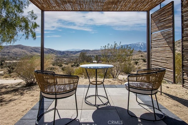 view of patio / terrace featuring a mountain view