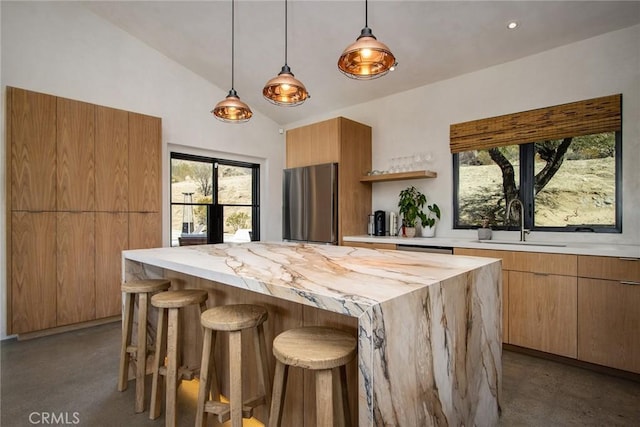 kitchen with finished concrete floors, modern cabinets, a sink, and stainless steel appliances