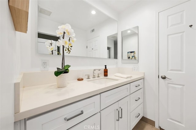 bathroom featuring vanity and recessed lighting