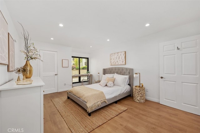 bedroom featuring recessed lighting, light wood-style floors, and baseboards