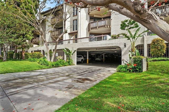 view of property with a garage and concrete driveway